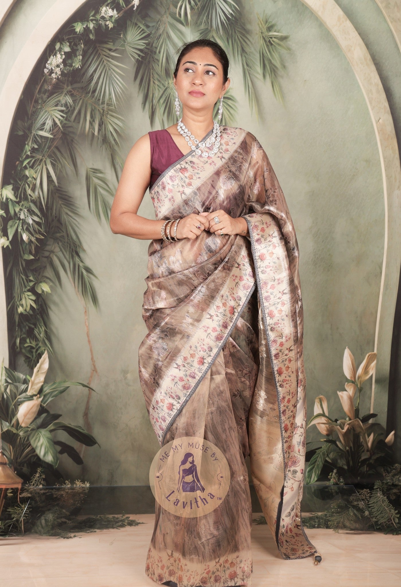 Our muse in a brown grey satin saree with digital floral print design and intricate floral design and crystal work on the border and pallu. This saree is part of the Dilqash collection from Me My Muse by Lavitha