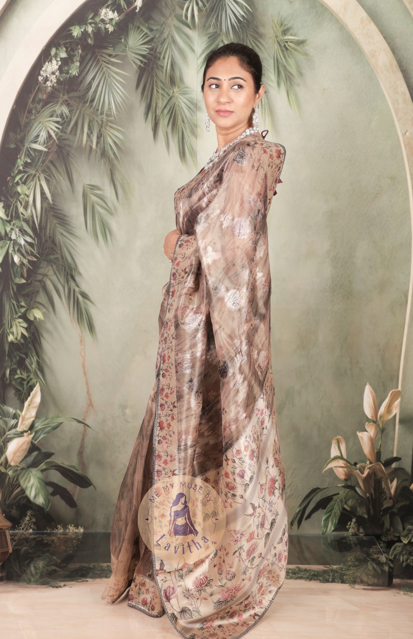 Our muse in a brown grey satin saree with digital floral print design and intricate floral design and crystal work on the border and pallu. This saree is part of the Dilqash collection from Me My Muse by Lavitha