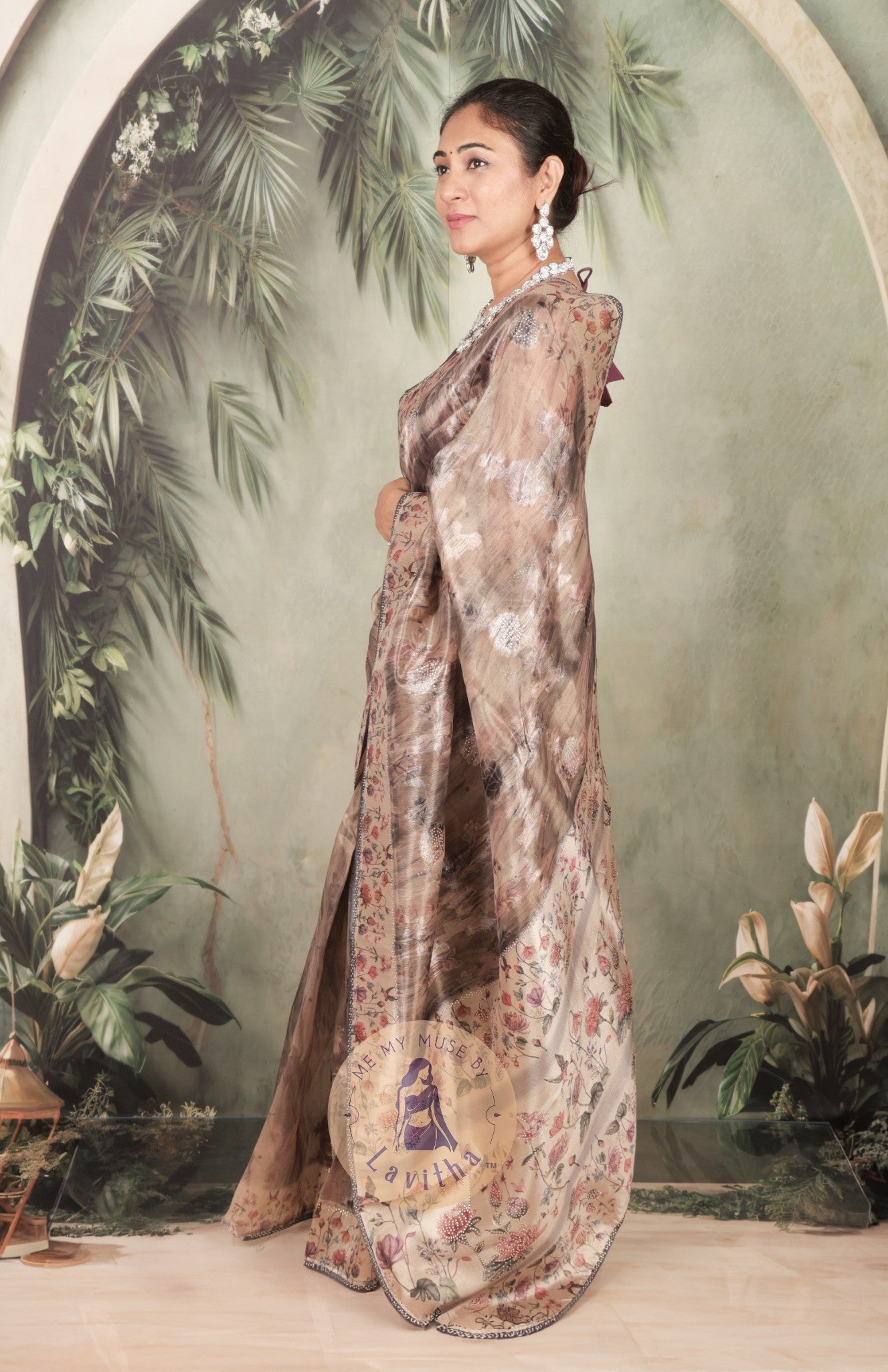 Our muse in a brown grey satin saree with digital floral print design and intricate floral design and crystal work on the border and pallu. This saree is part of the Dilqash collection from Me My Muse by Lavitha