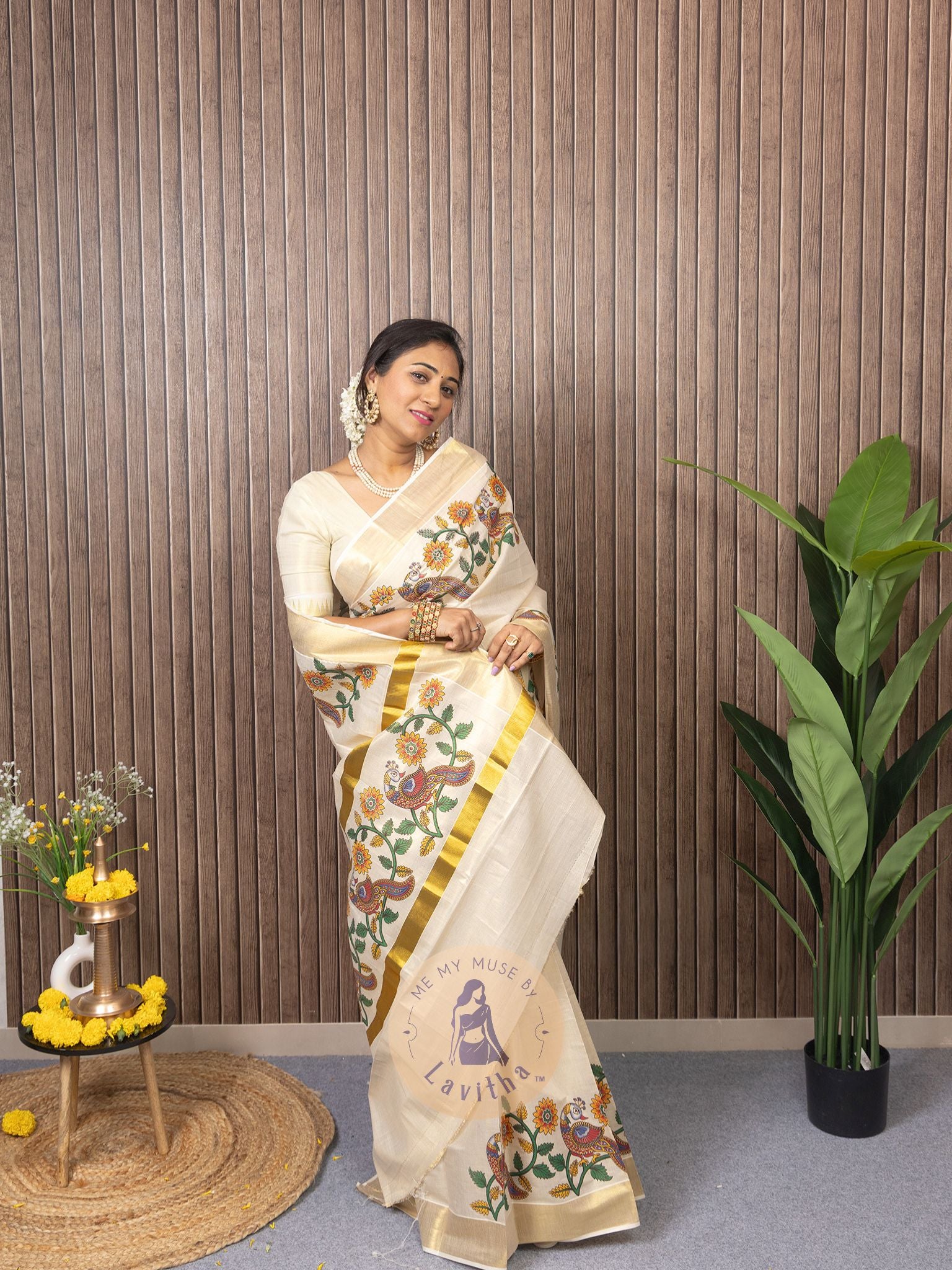 Our muse in a cream and gold Kerala Kasavu Tissue Silk saree with peacock and floral prints exclusively available on Me My Muse by Lavitha
