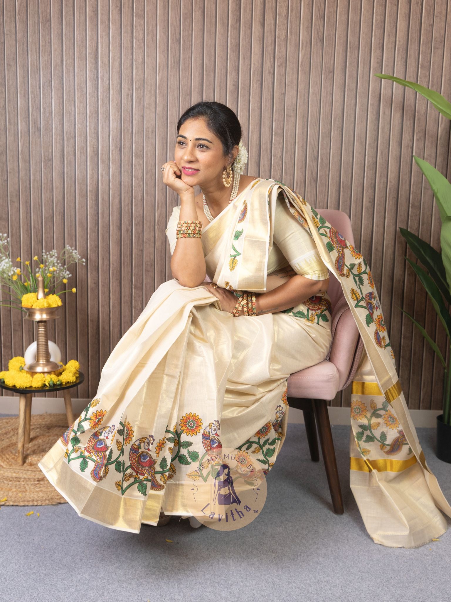 Our muse in a cream and gold Kerala Kasavu Tissue Silk saree with peacock and floral prints exclusively available on Me My Muse by Lavitha