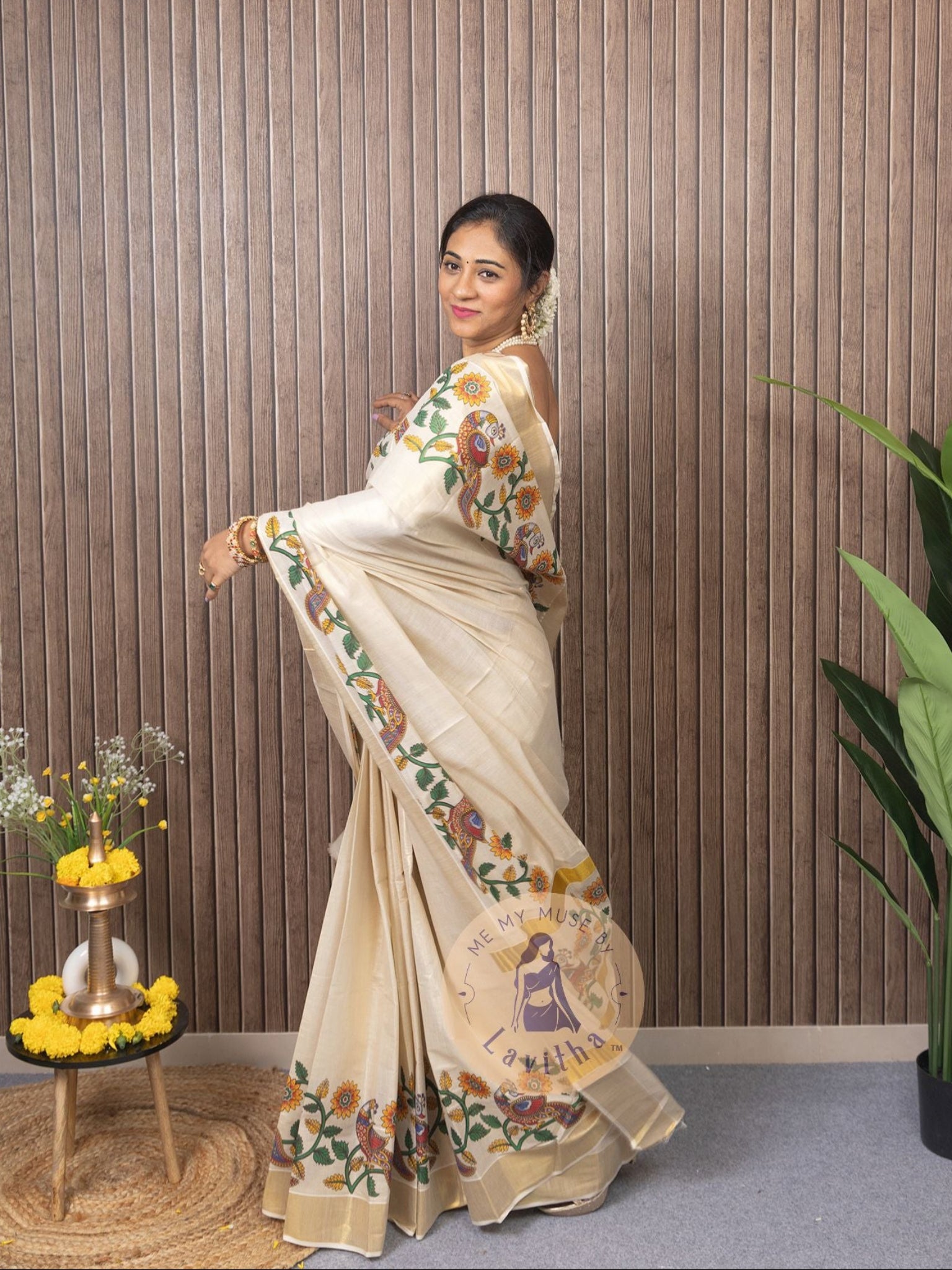 Our muse in a cream and gold Kerala Kasavu Tissue Silk saree with peacock and floral prints exclusively available on Me My Muse by Lavitha
