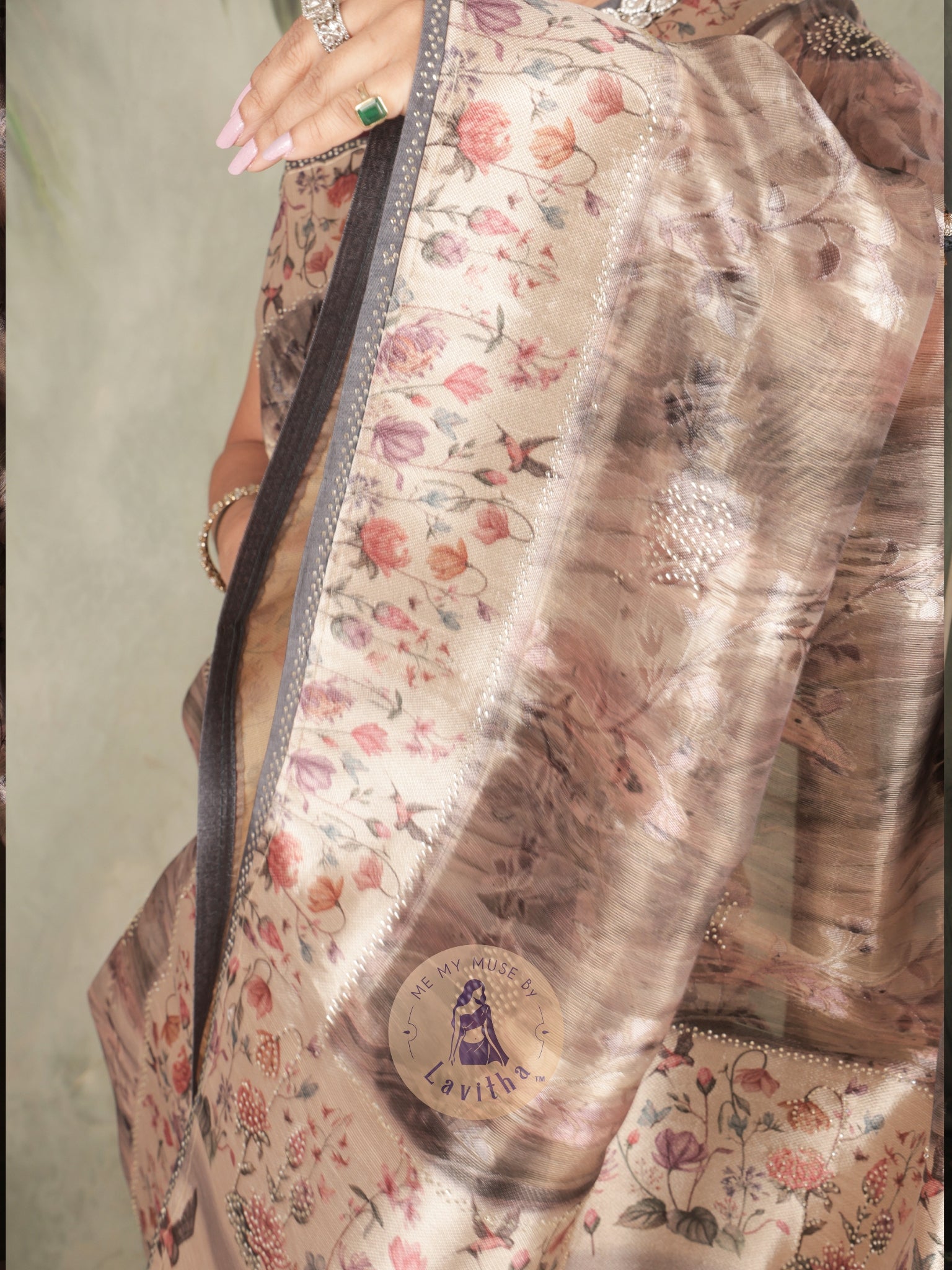 Our muse in a brown grey satin saree with digital floral print design and intricate floral design and crystal work on the border and pallu. This saree is part of the Dilqash collection from Me My Muse by Lavitha