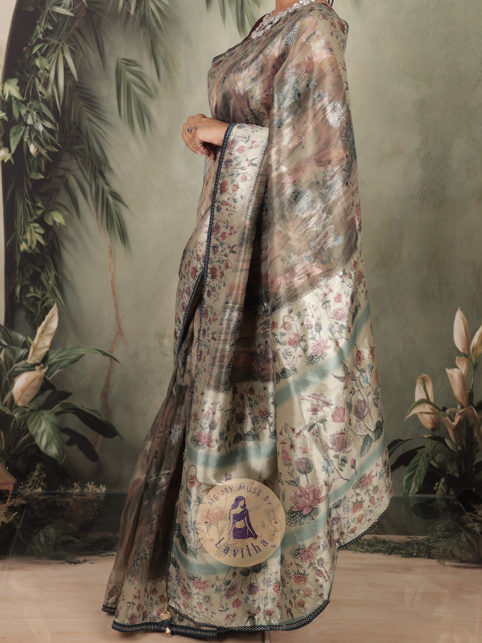 Our muse in a grey green satin saree with digital floral print design and intricate floral design and crystal work on the border and pallu. This saree is part of the Dilqash collection from Me My Muse by Lavitha