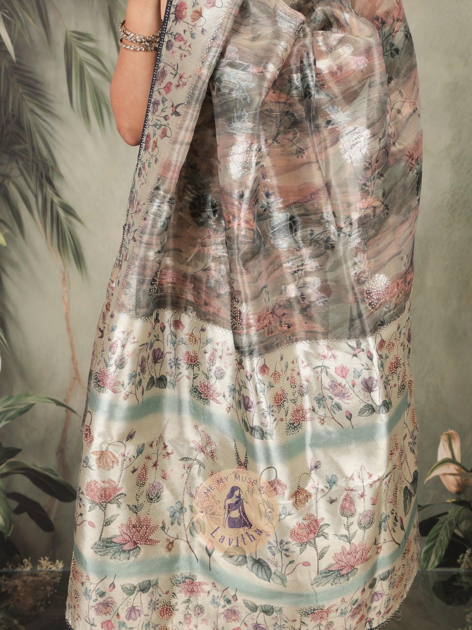 Our muse in a grey green satin saree with digital floral print design and intricate floral design and crystal work on the border and pallu. This saree is part of the Dilqash collection from Me My Muse by Lavitha