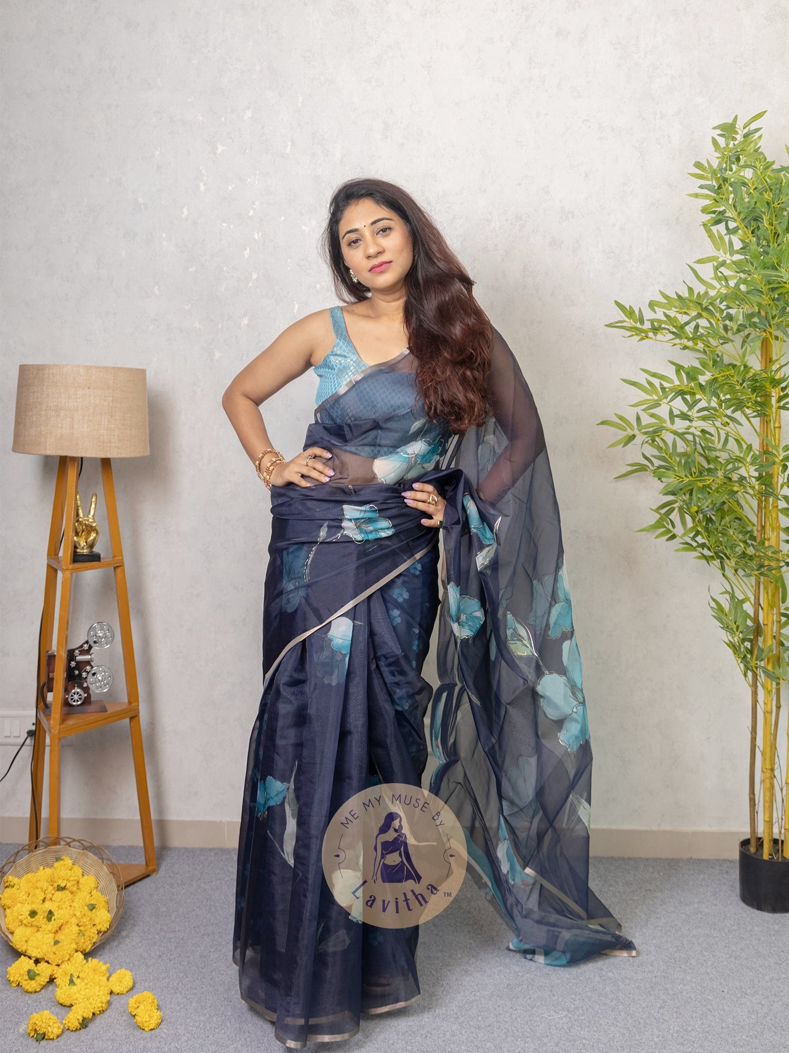 Our muse in a dark blue organza printed saree with floral patterns and thin gold border from Me My Muse by Lavitha