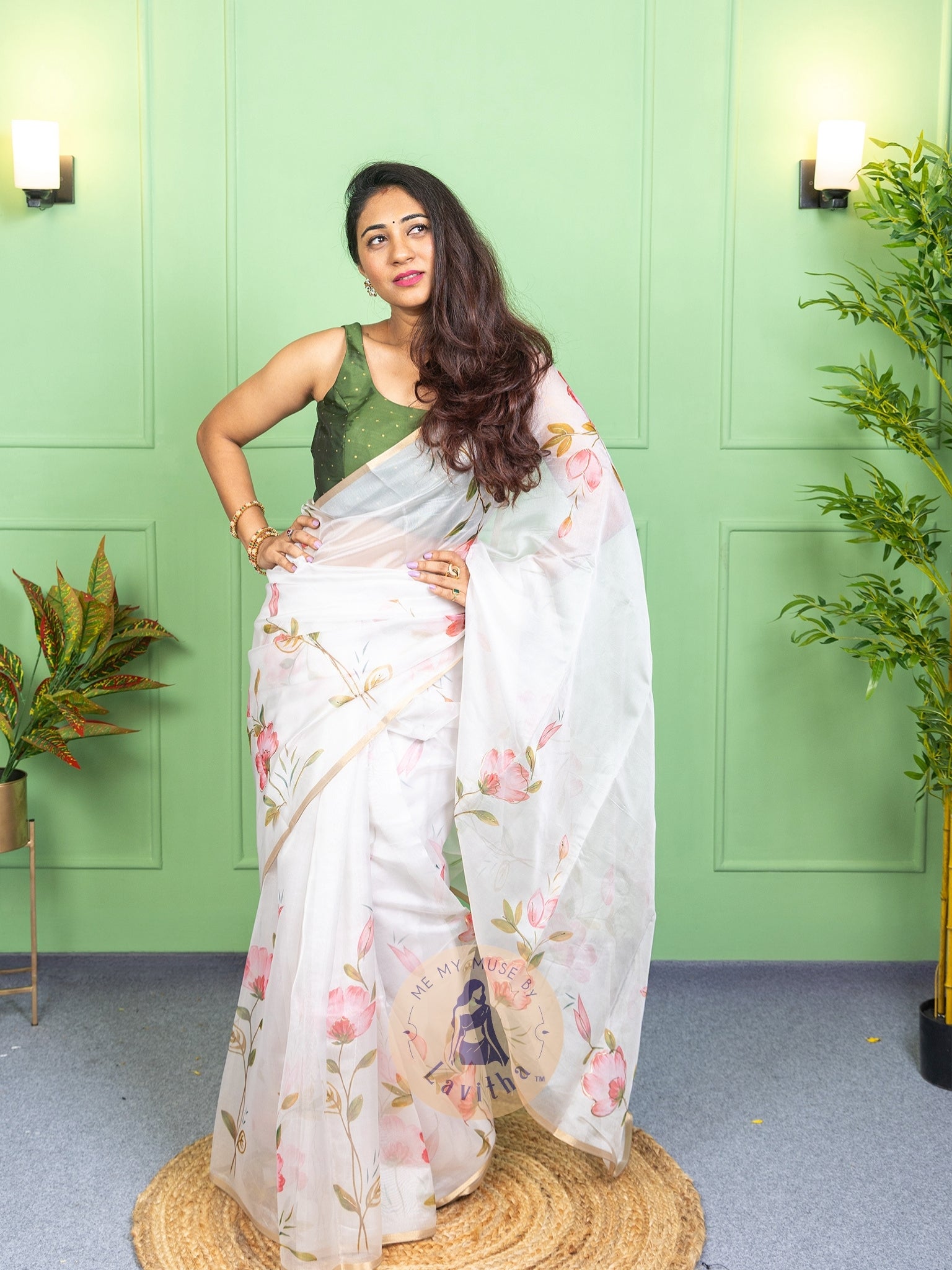 Our muse in a white organza printed saree with floral patterns and thin gold border from Me My Muse by Lavitha