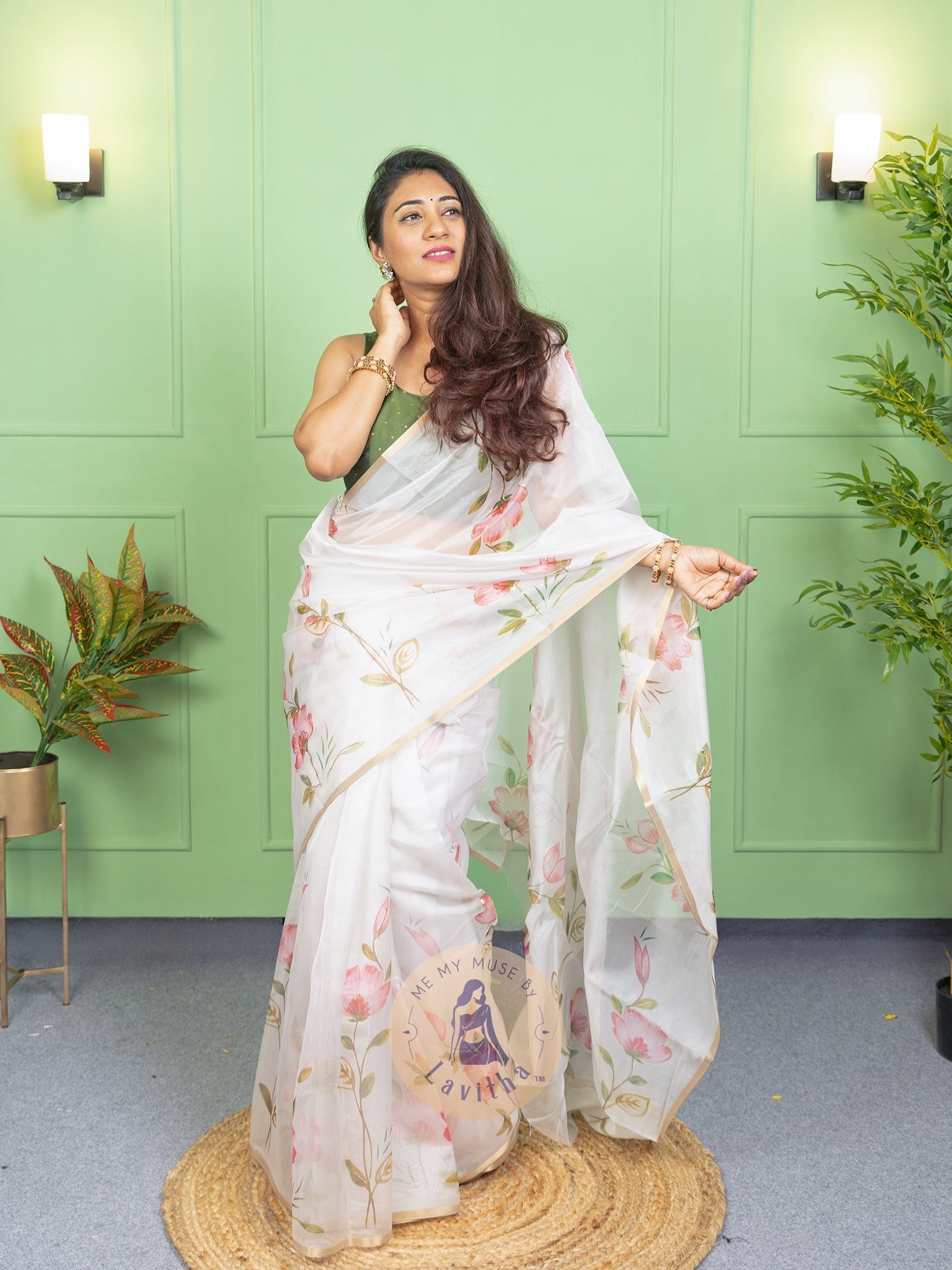 Our muse in a white organza printed saree with floral patterns and thin gold border from Me My Muse by Lavitha