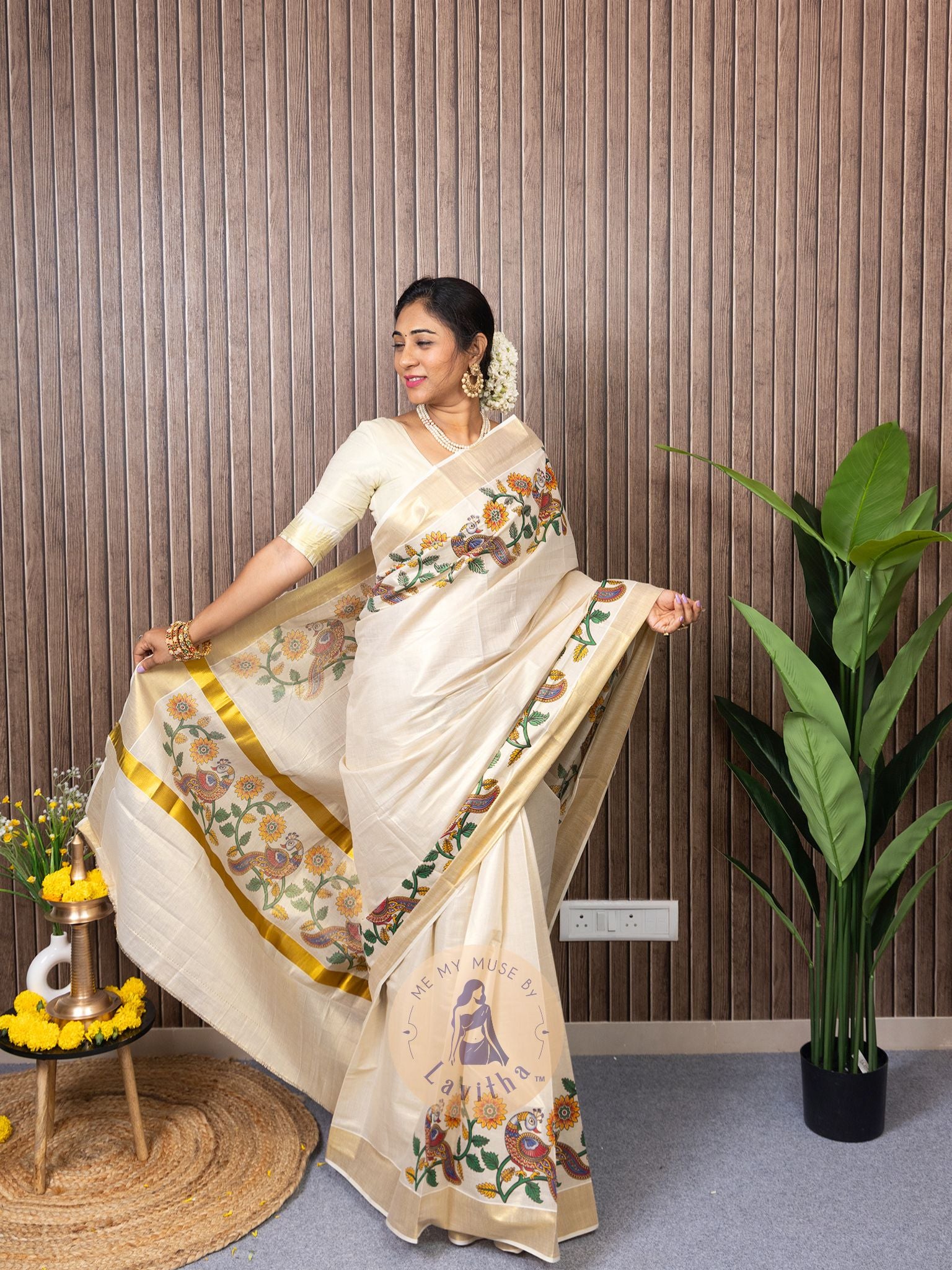 Our muse in a cream and gold Kerala Kasavu Tissue Silk saree with peacock and floral prints exclusively available on Me My Muse by Lavitha