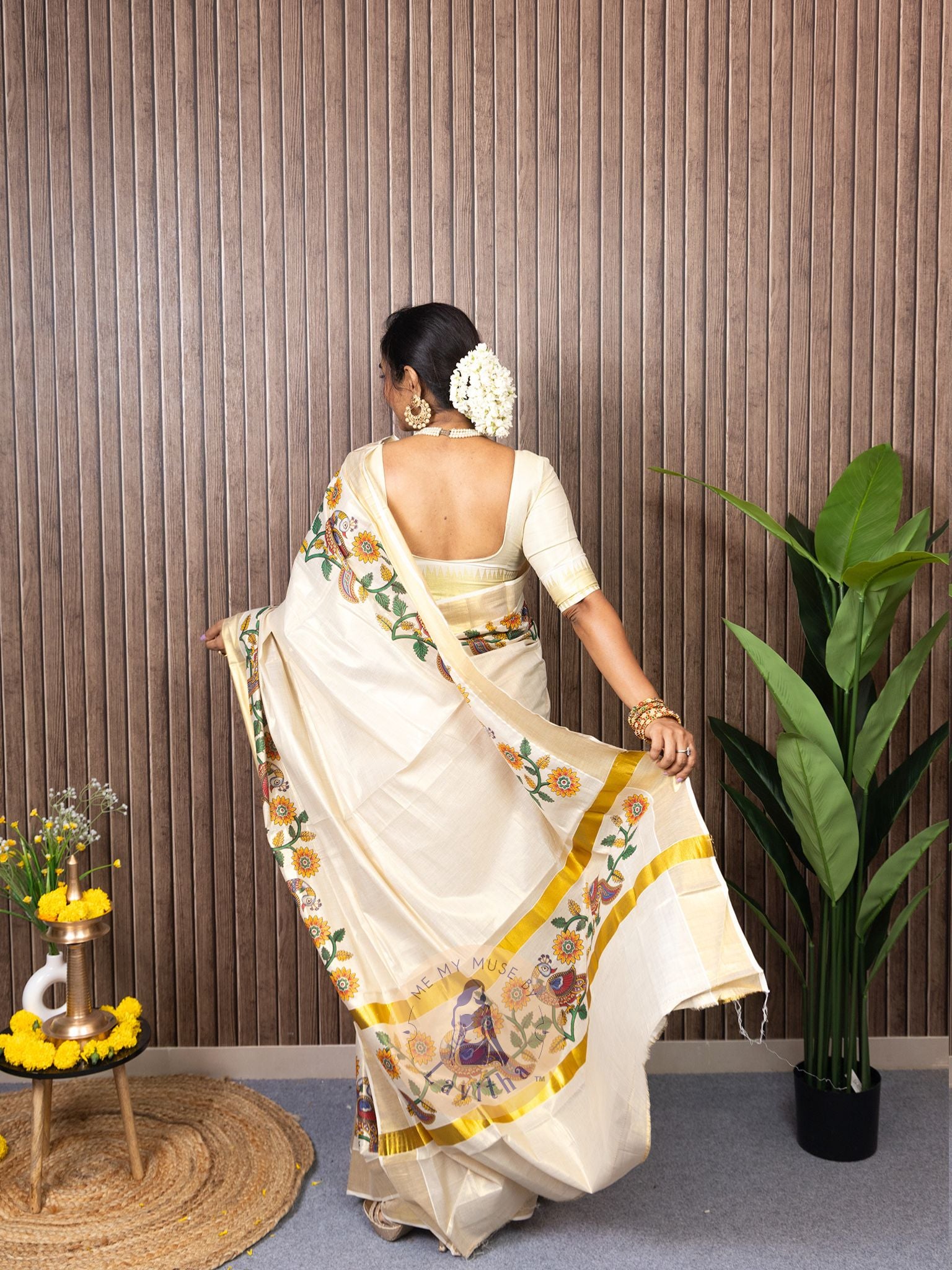 Our muse in a cream and gold Kerala Kasavu Tissue Silk saree with peacock and floral prints exclusively available on Me My Muse by Lavitha