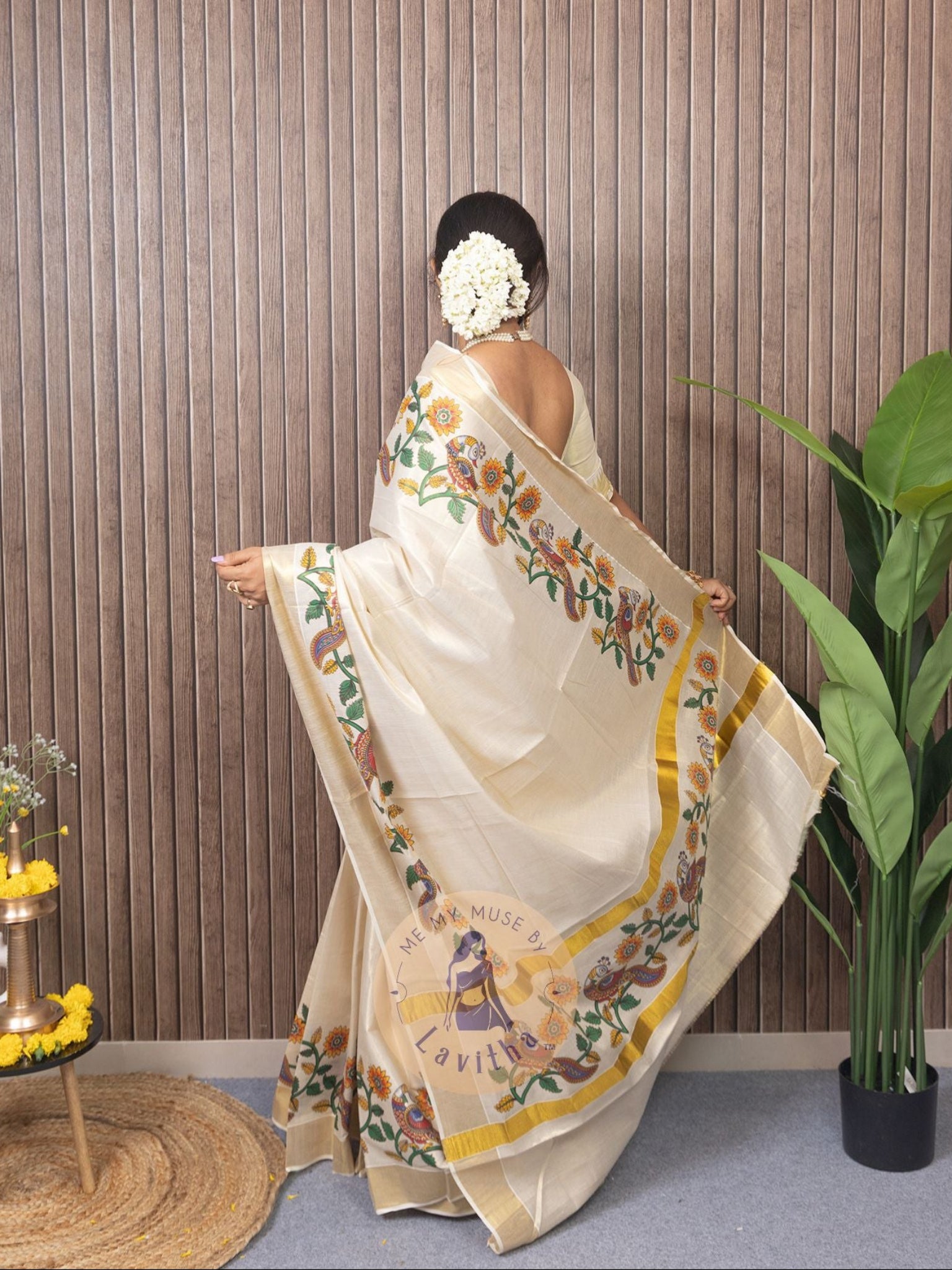 Our muse in a cream and gold Kerala Kasavu Tissue Silk saree with peacock and floral prints exclusively available on Me My Muse by Lavitha