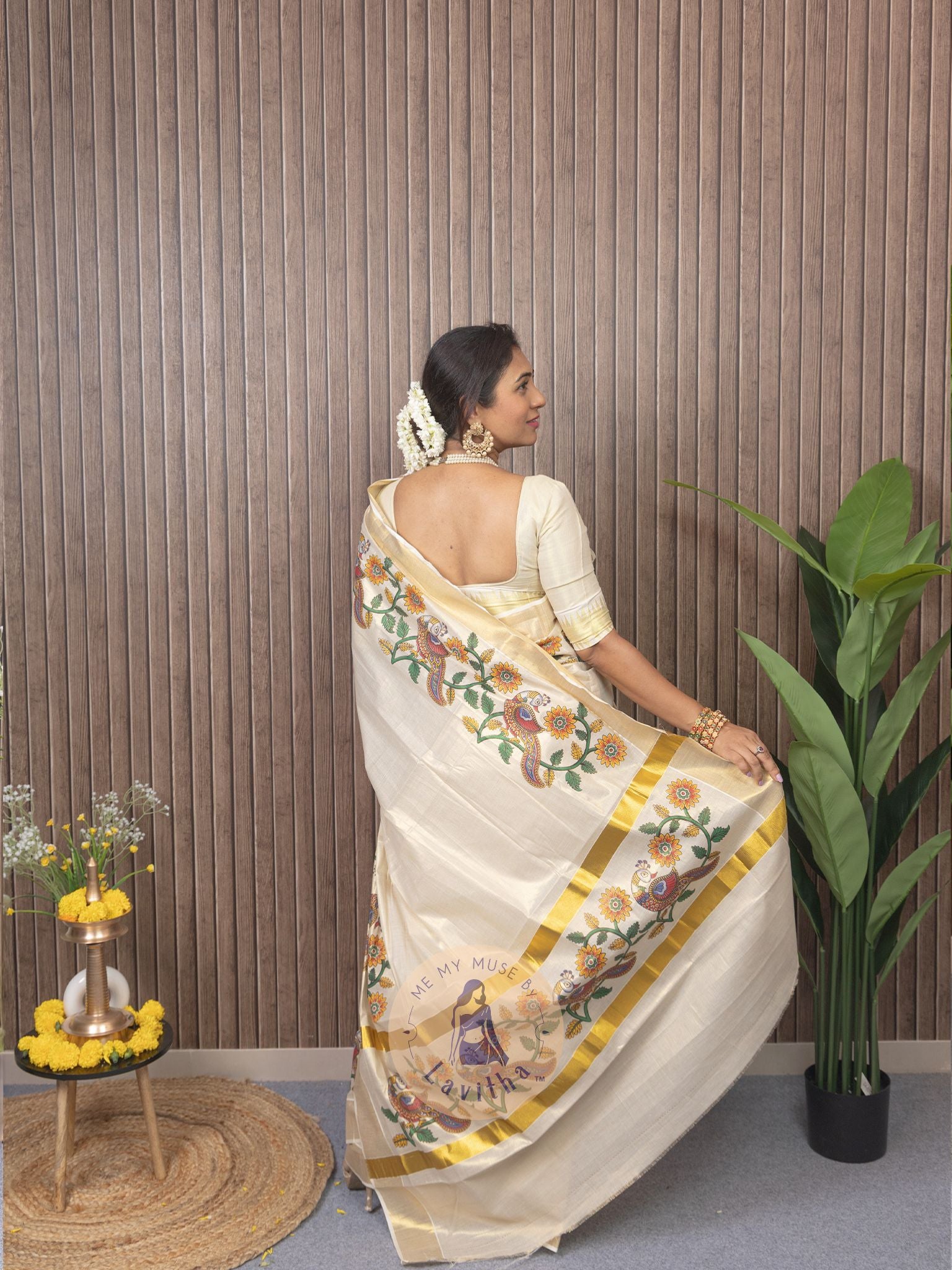 Our muse in a cream and gold Kerala Kasavu Tissue Silk saree with peacock and floral prints exclusively available on Me My Muse by Lavitha